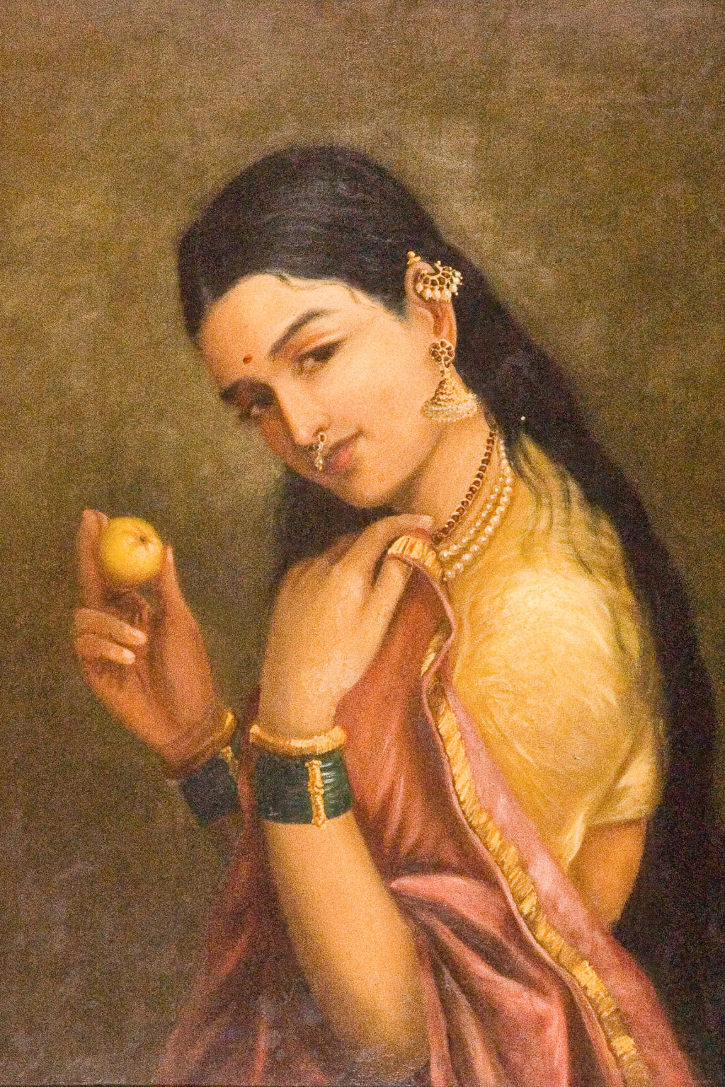 Woman Holding a Fruit (Late 19th Century) by Raja Ravi Varma — unframed artwork